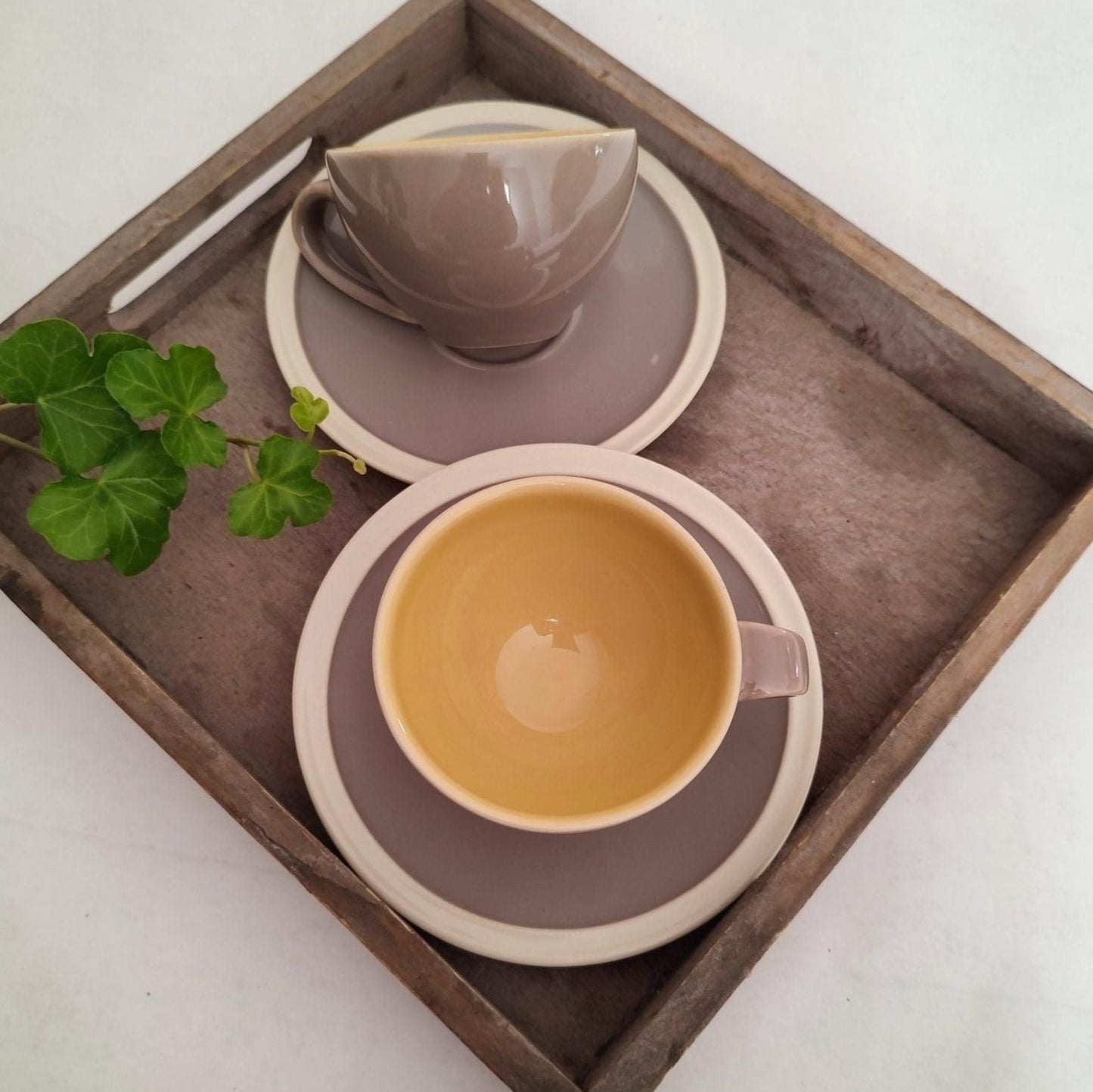 bougie à la cire de soja 100% végétale, coulée dans une tasse à café en céramique portugaise de couleur gris/taupe avec des grains de café. Made in Portugal