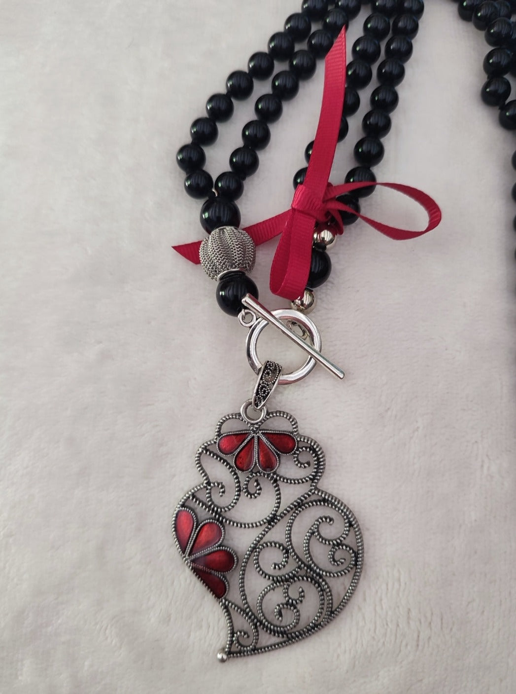  Sautoir collier portugais en perles de couleur noir avec pendentif Cœur de Viana, coração de Viana en filigrane et gouttes rouges, & petit ruban rouge, réalisé à la main,  fabriqué au Portugal,